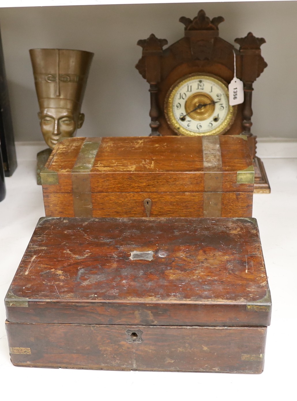 A brassbound box, a writing slope, a mantle clock, 37.5cm tall, and a bust of Nefertiti